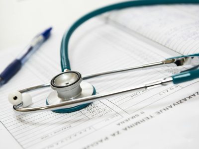 medical-appointment-doctor-healthcare-40568-40568 A stethoscope and pen resting on a medical report in a healthcare setting.