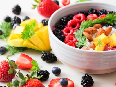 pexels-photo-1105166-1105166 A vibrant bowl filled with fresh berries, mango, almonds, and herbs, perfect for a healthy snack or breakfast.