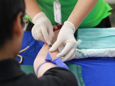 pexels-photo-1350560-1350560 A healthcare professional administering an injection to a patient's arm during a medical procedure.